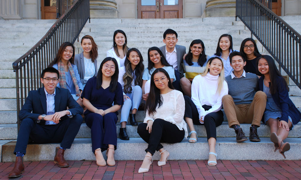 Asian American Center team sitting on steps